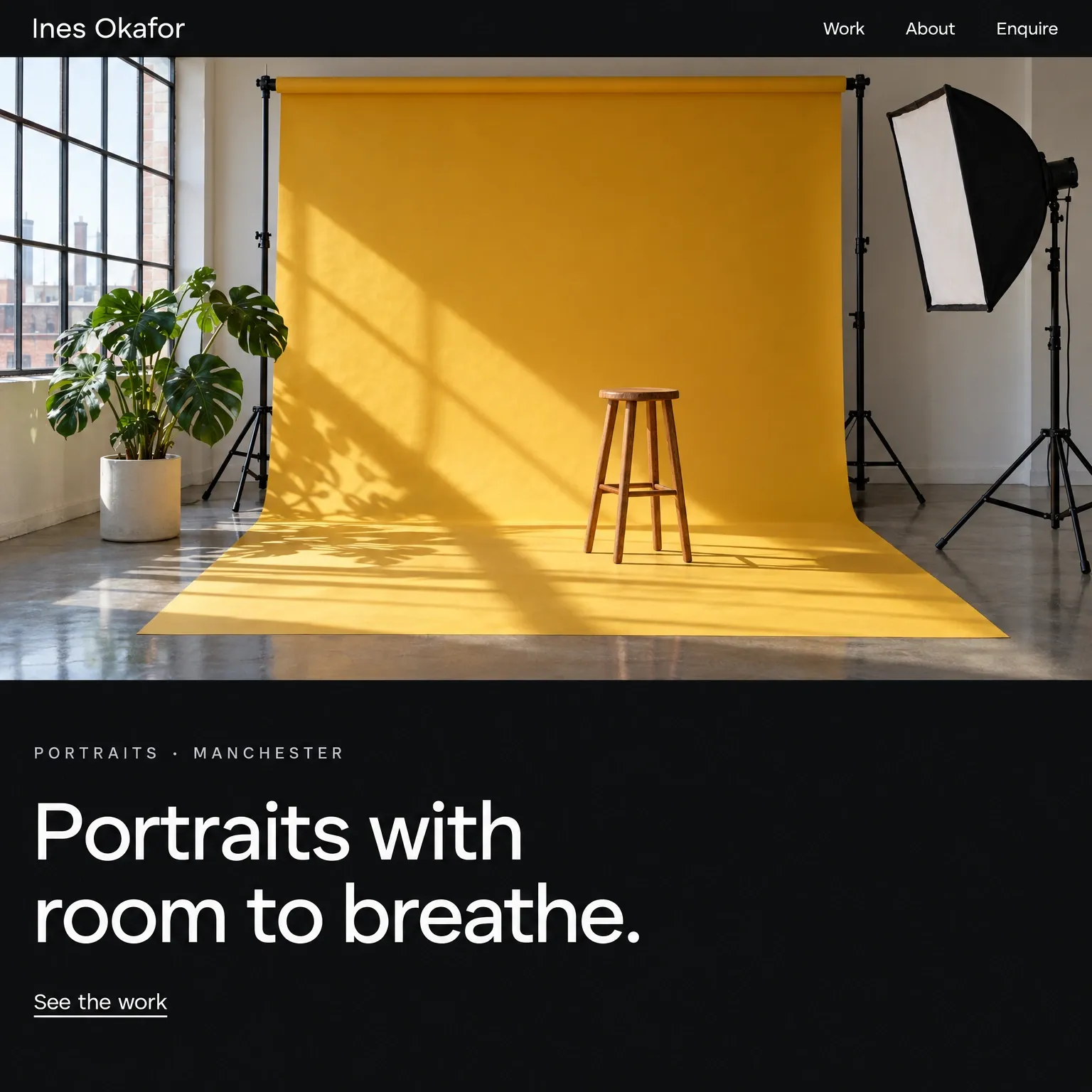 A photographer’s homepage: near-black, a wide white headline and a photograph of a studio with a mustard backdrop